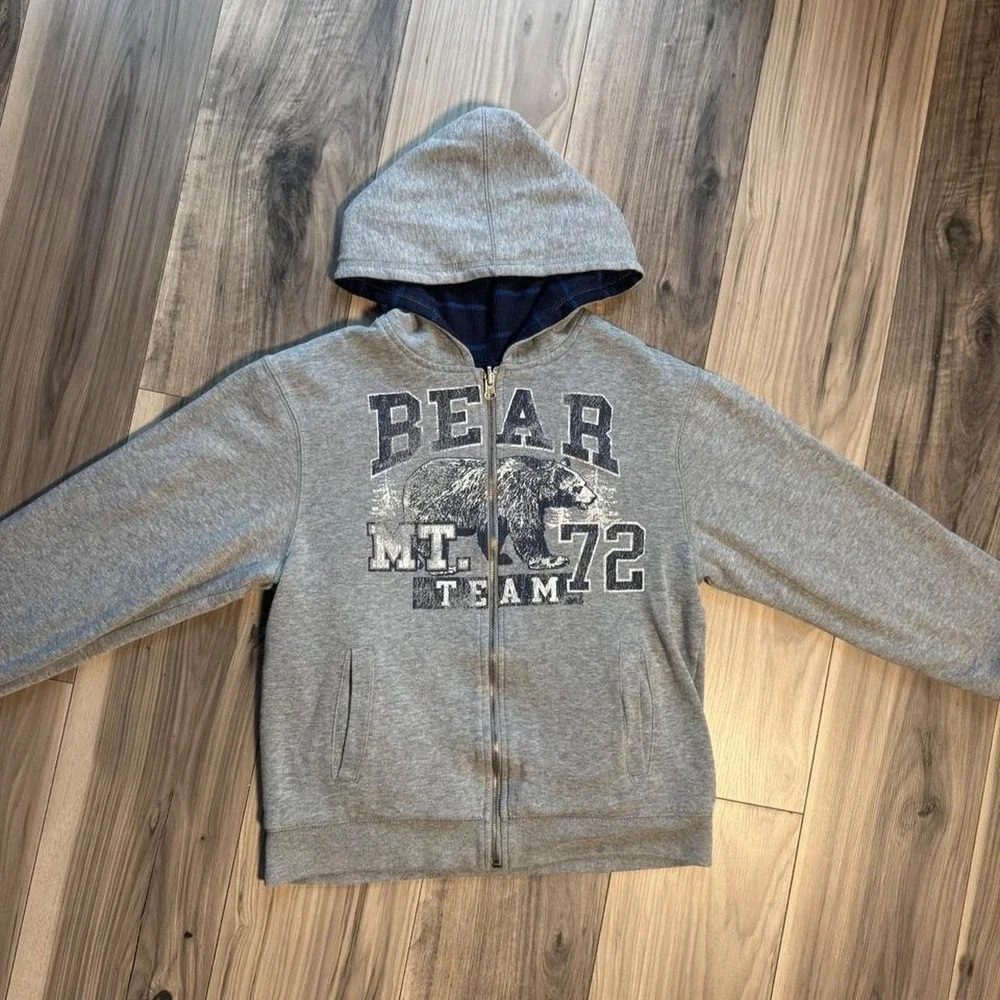 Heavy-duty, double-lined reversible gray zip-up hoodie featuring a bear